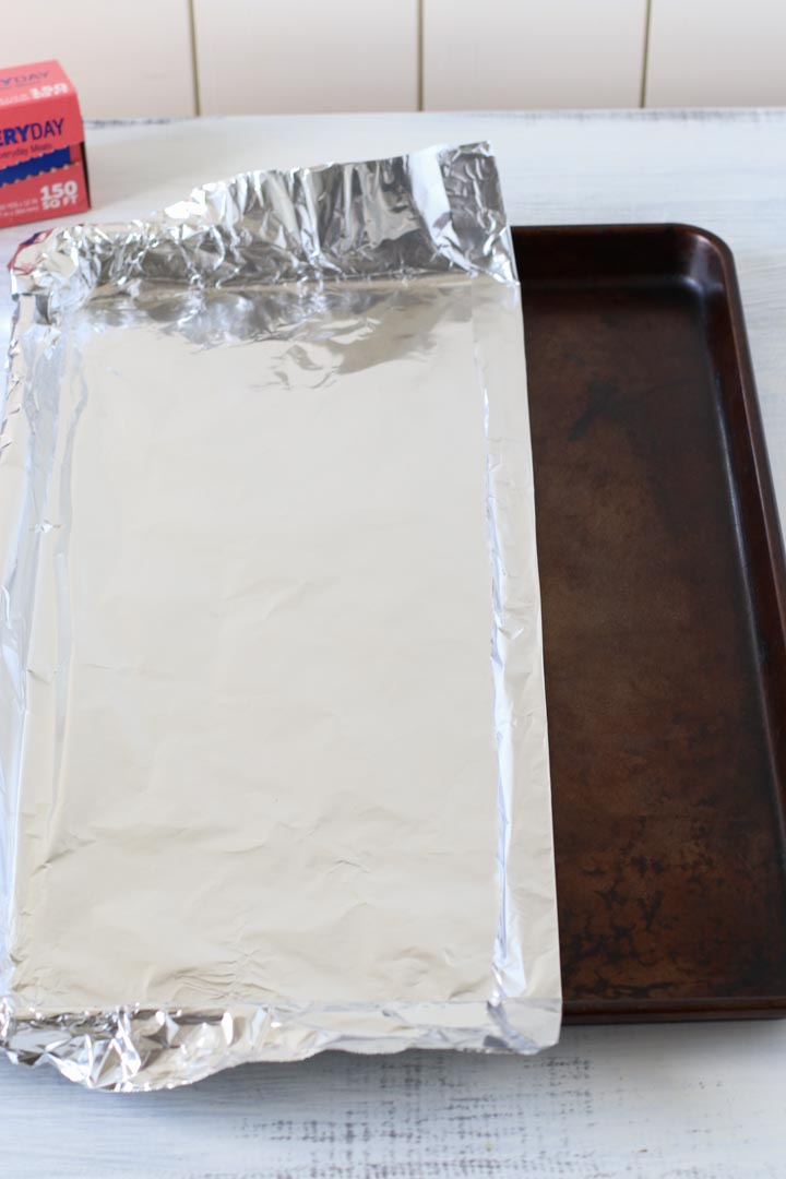 Applying aluminum foil to a rimmed baking pan