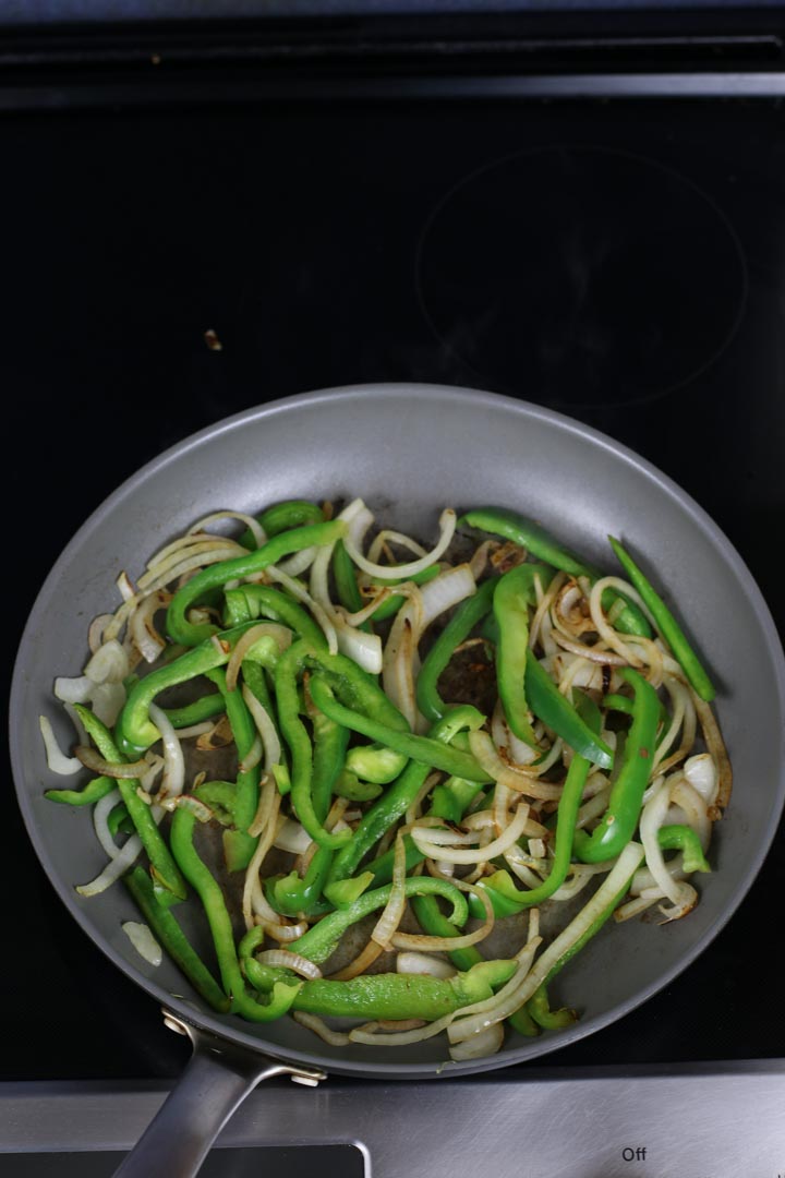 Lightly sauteed green peppers and onions on a pan