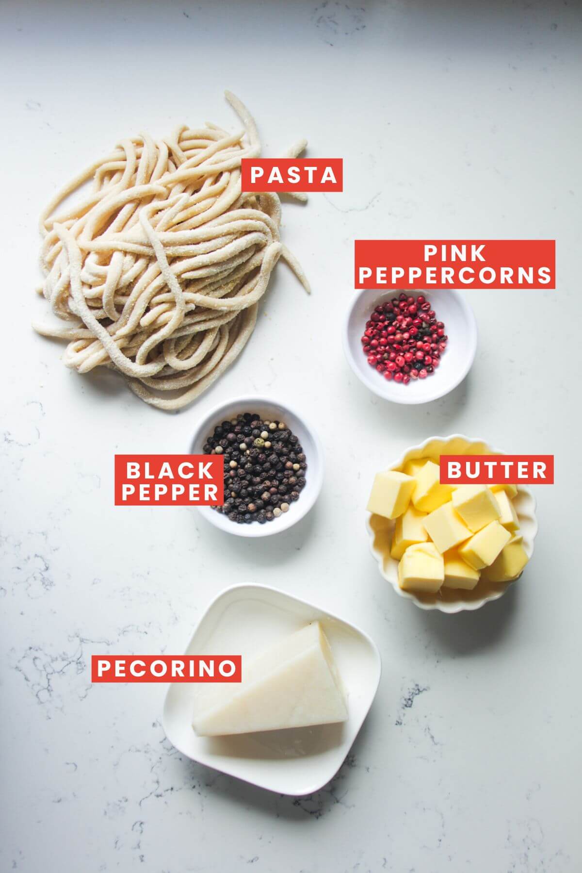 Ingredients for cacio e pepe laid out and labelled.